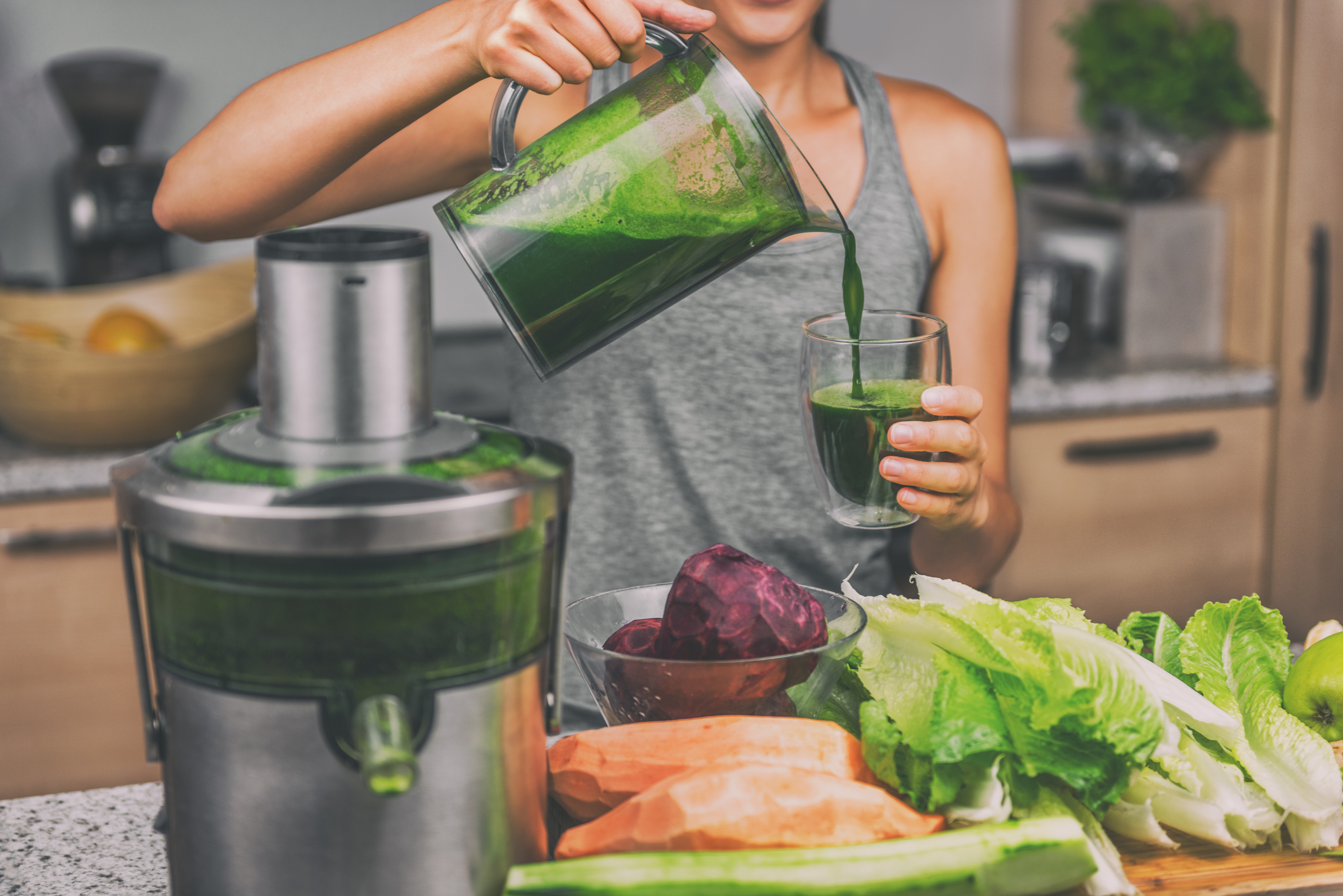 Woman Juicing Green Juice with Home Juice Machine